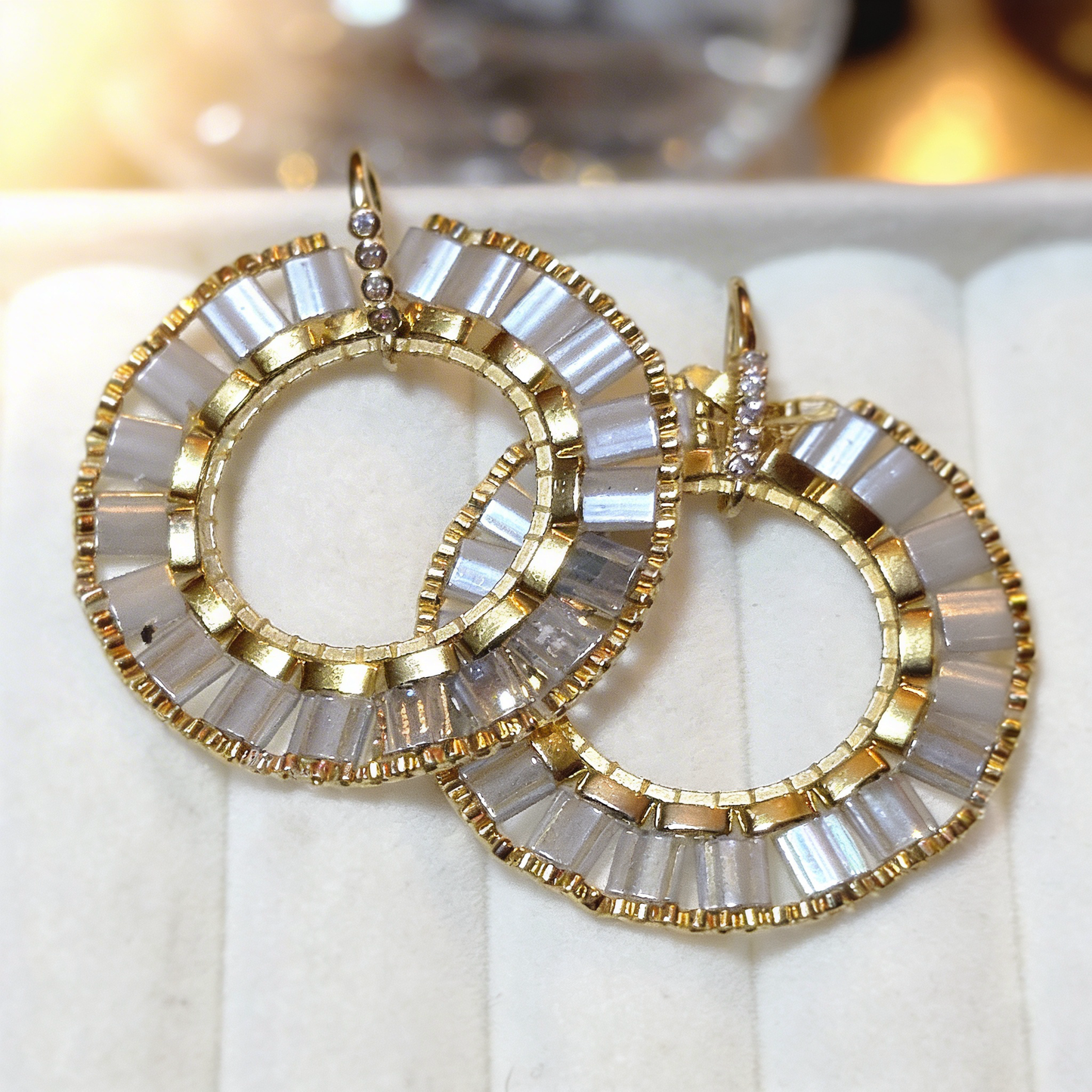 Gold hoop earrings with ivory Miyuki tila beads in halo form circular design, airy minimalist luxury jewelry